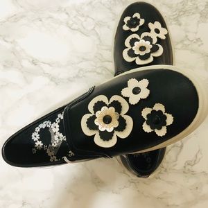 Black and white floral slip on sneakers